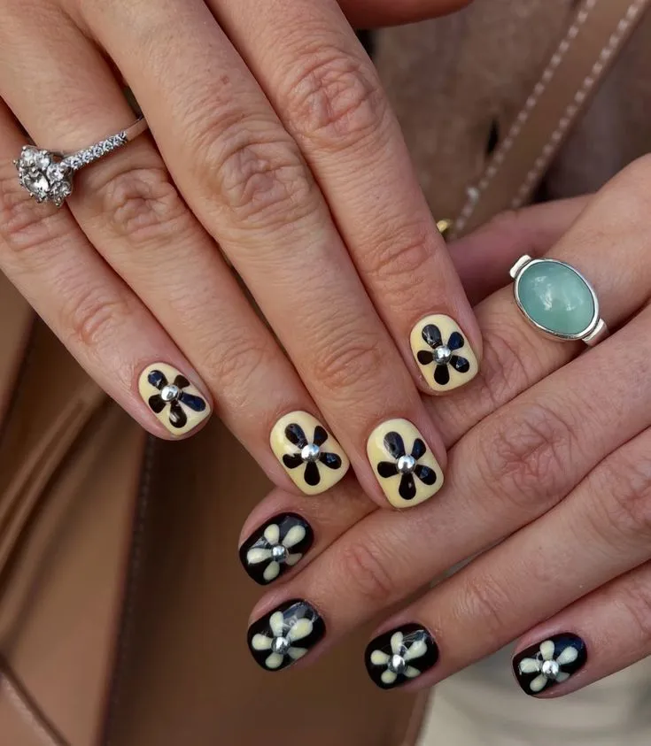 Geometric flower square nail designs - modern hand showcasing geometric flower patterns, featuring clean lines and structured floral elements on square-shaped nails